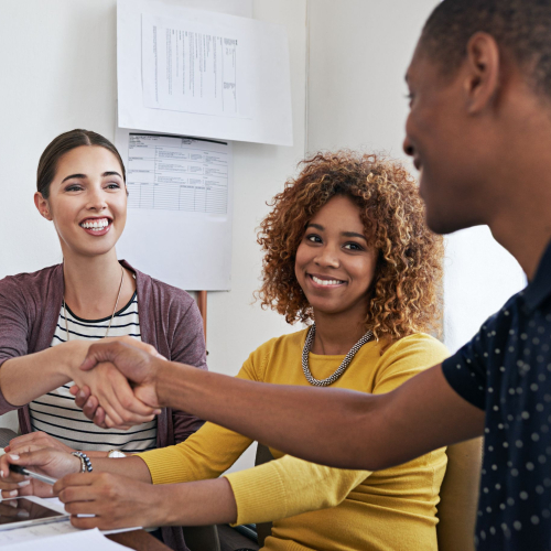 shot of coworkers shaking hands during a meeting i 2023 11 27 05 15 02 utc